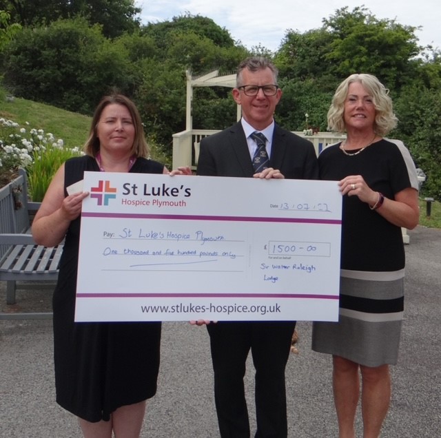 Andrew & Alyson McConaghy present a cheque to Sarah Wallis, Partnership Lead at St Luke's Hospice