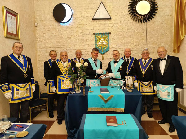 Worshipful Master Chris Williams presents an engraved gavel to the Worshipful Master of Vilnius Arch Lodge.