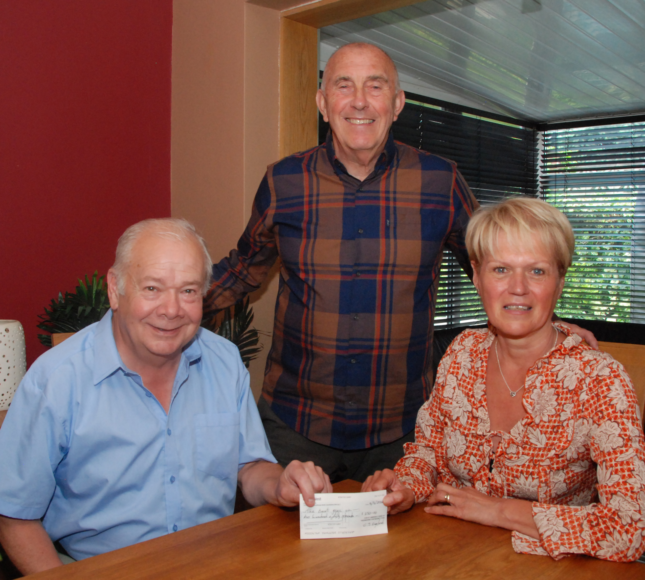 Scunthorpe Freemason Dave Gibson, left, hands the £250 donation from St Lawrence Lodge to Gill Ayling watched by husband Steve.