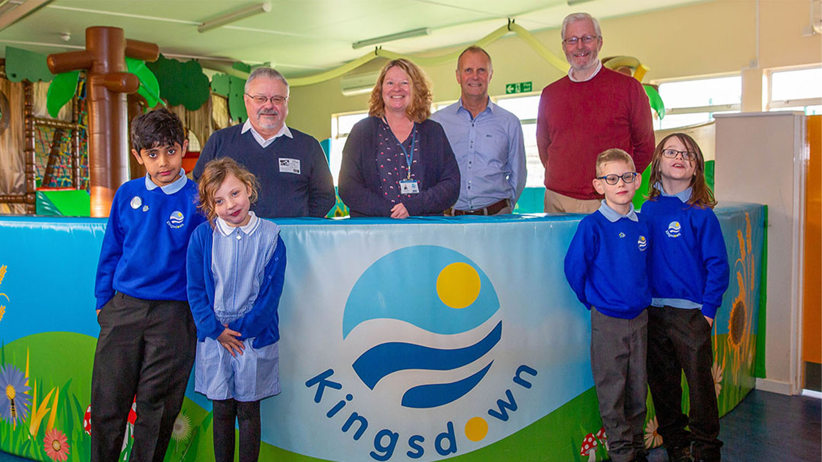 David Wilson (back row right) presenting £500 to Louise Robinson (back row centre) Headteacher Kingsdown School on behalf of Essex Royal Arch Masons.