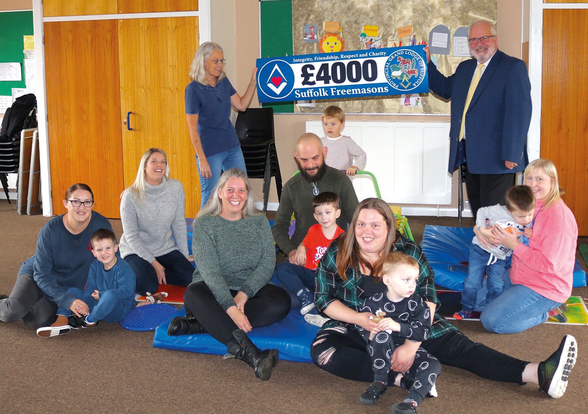 Ipswich Representative Kelvin Larcombe with Charity Co-ordinator Cheryl King, children and Suffolk Freemasons' donation.